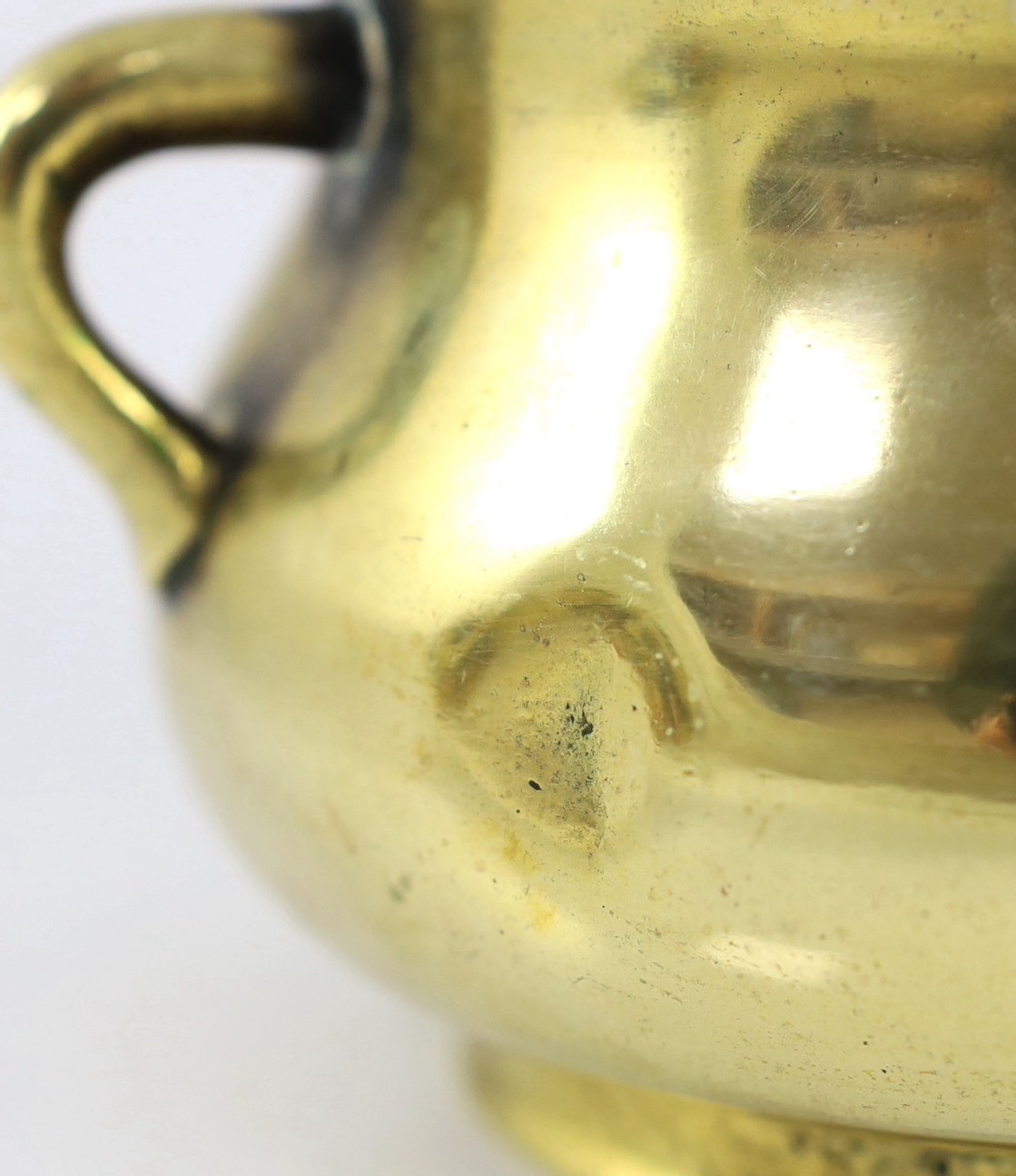 A Chinese polished bronze censer, gui, Xuande six character mark, 18th/19th century, 19cm wide, dented, solder repair